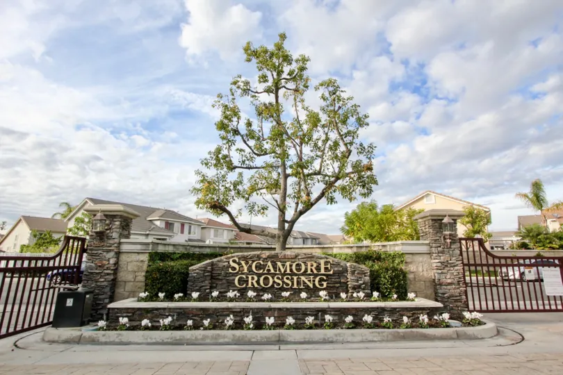 The gorgeous gates to Sycamore Crossing on a bright but cloudy day Sycamore Crossing, Orange California.