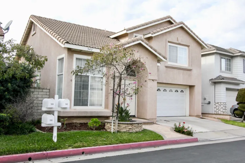 Beige house with small lawn in front, alon with garage in the Sycamore Crossing neighborhood