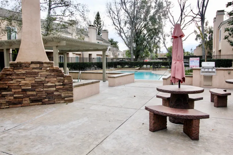 The patio by the pool in Tamarin Orange with tables and benches