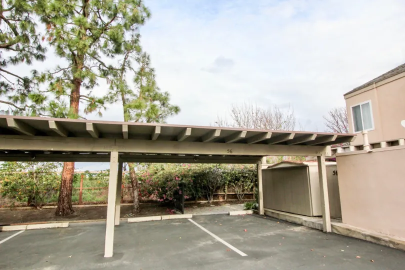 The covered parking lot in the Tamarin Orange community on a partly cloudy day.