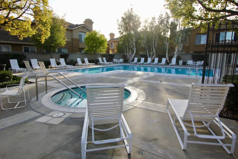 swimming pool decorated with chairs and plants around in The Bluffs at Belmont