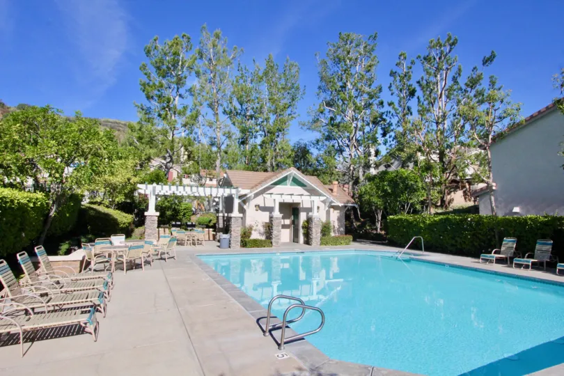swimming pool decorated with chairs and plants around in The Village
