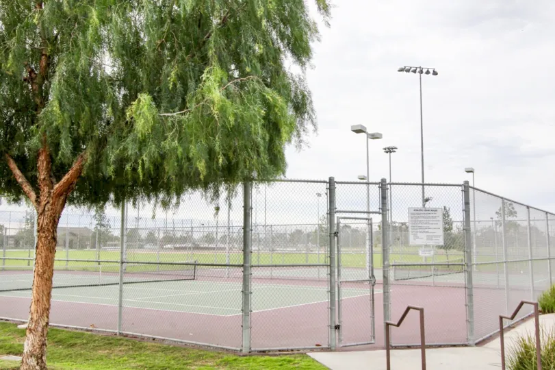The tennis courts outside Timber Hill with a fence surrounding it