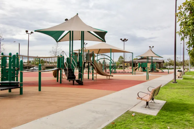 A large decked out playground on top of safety padded ground in Timber Hill at Orange CA