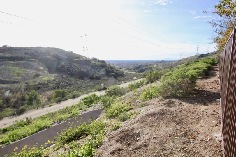 A narrow road viewed from a top of a hillock inside the Tremont community