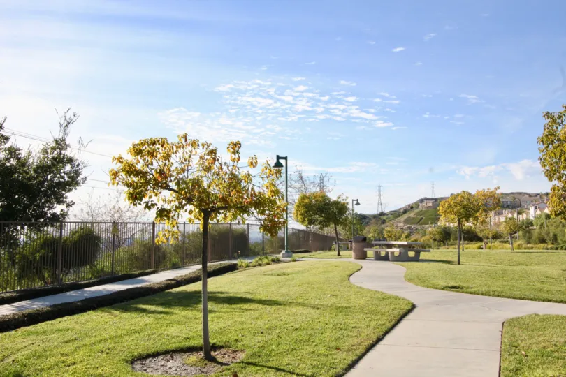 A park in the Tremont community with tree and benches.