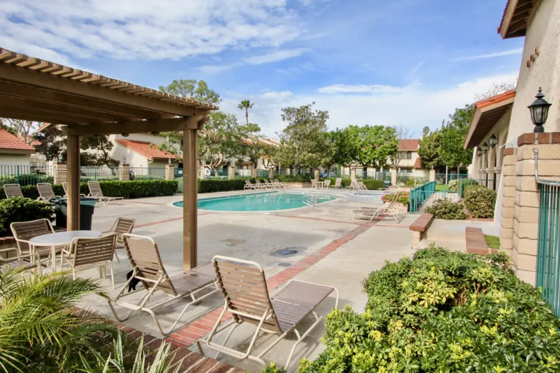 A pool lined with chairs belonging to the gated community of Vista Monterey in Orange California.
