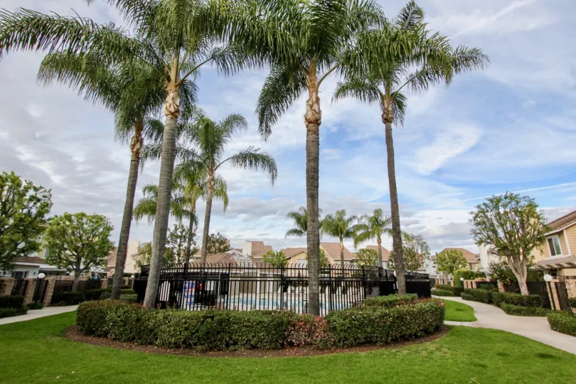 An overcast sky abovea large bunglow surrounded by a large garden in the vista Santiago community