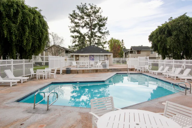 A morning in the Walnut Village with a swimming pool and chairs.