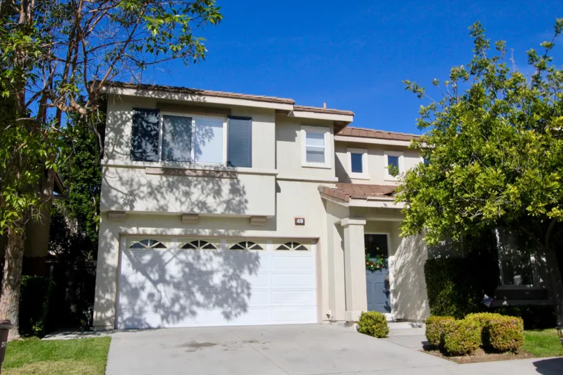Bright sunny day with parking place and trees near villa in Ballantree of Rancho Santa Margarita