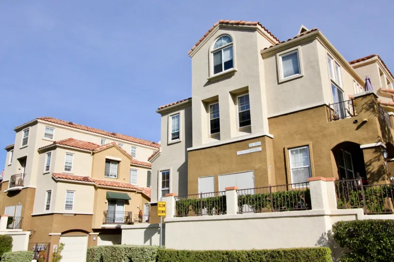 A sunny day in the area of Barcelona, outside, condos, windows, balcony, bushes, sky