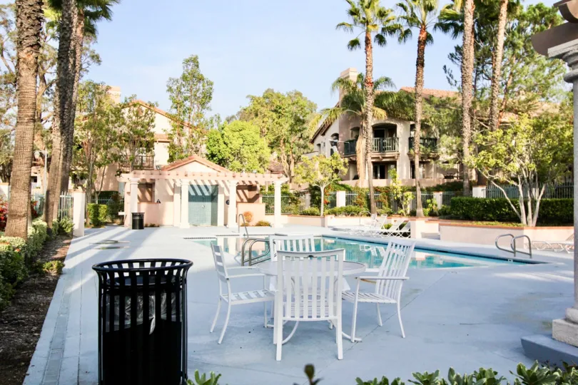 Cool looking swimming pool with sitting and palm trees around in Bella Ventana of Rancho Santa Margarita
