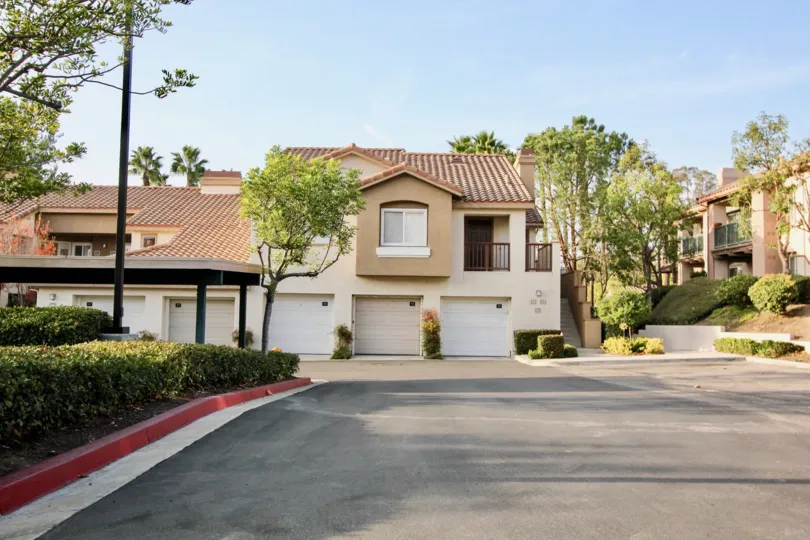 A red curb sits by a row of short hedges in the Bella Ventana community