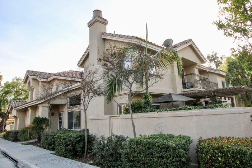 A view from the sidewalk of a home and walled-in patio in Rancho Santa Margarita, CA