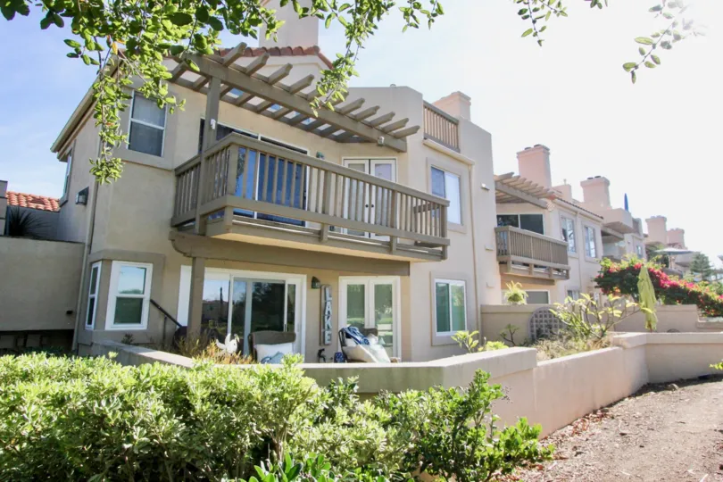 A pergola sits above a balcony at the Brisa Del Lago I community