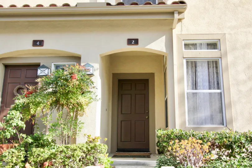 A brown wreath sits on the brown door on the left at Cabo Vista condos