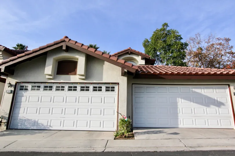 Two garage doors with a red roof in Candelero community in Rancho Santa Margarita, California.