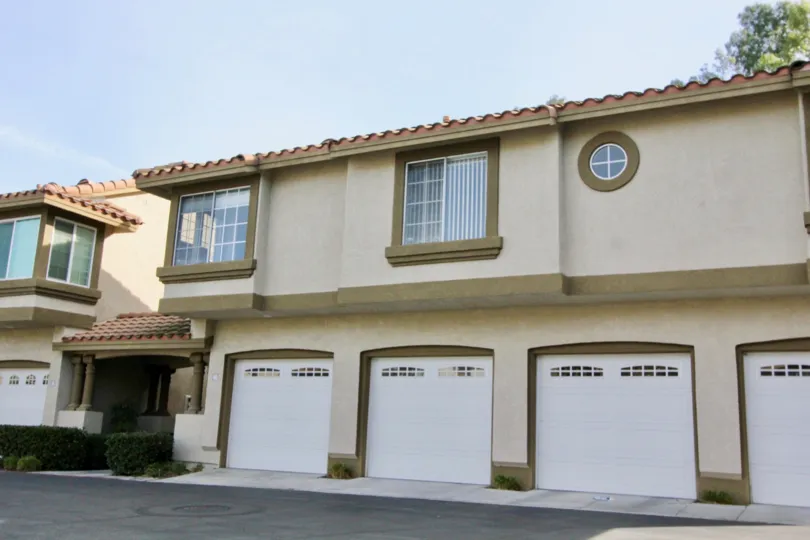 A small round privacy window sits on a tall wall in the Casafina community.
