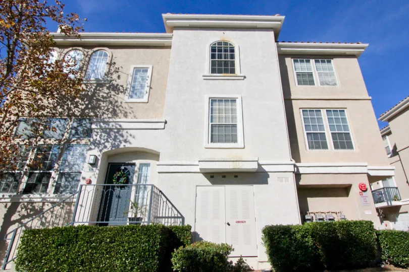 A very large light colored home with bushes in Cierra Del Lago community in Rancho Santa Margarita, California.