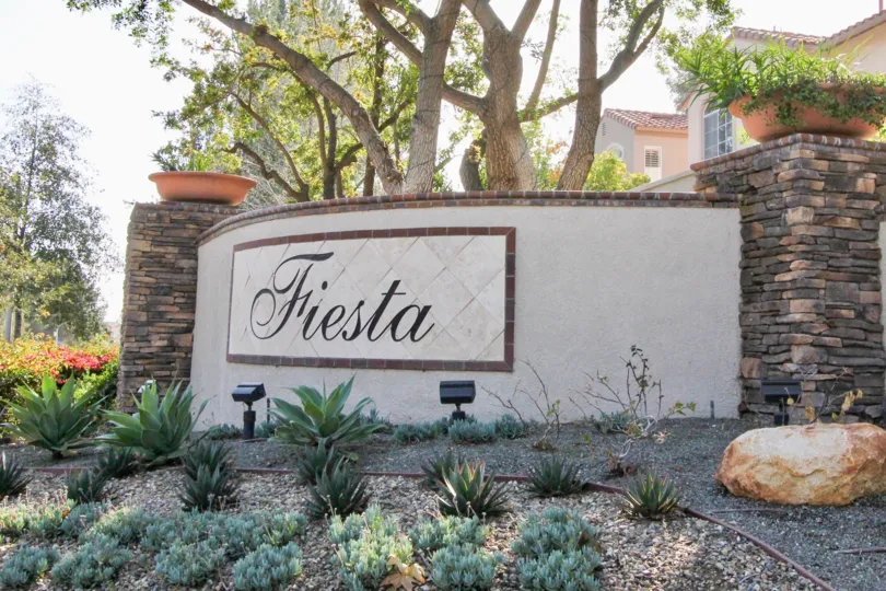 A stone signage with spot lighting in the Fiesta community.