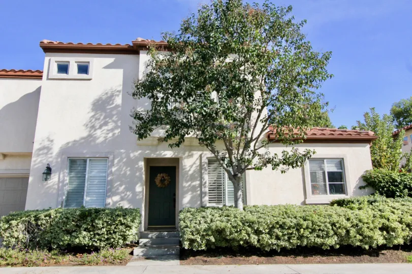 A sunny day in the area of Fiesta, outside, tree, door, windows, condo