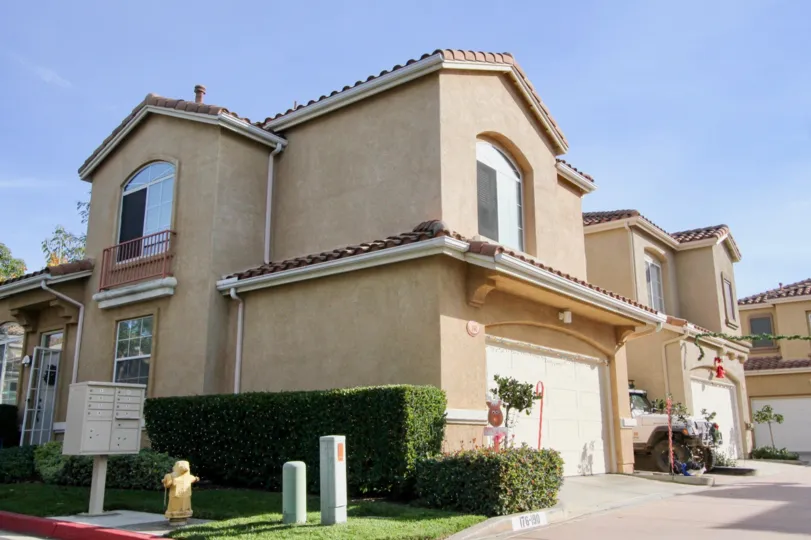 A sunny day in the area of Los Abanicos, outside, condo, garages, bushes, windows
