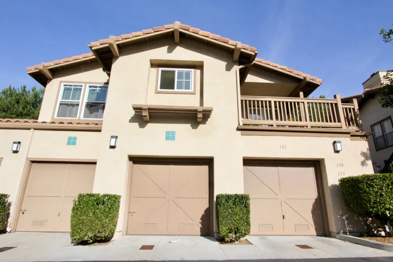 A balcony sits above a garage in the Los Portillos community