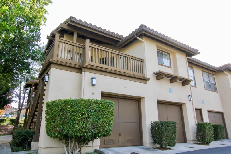 A sunny day in the area of Los Portillos, condo, outside, garages, stairs, trees, balcony