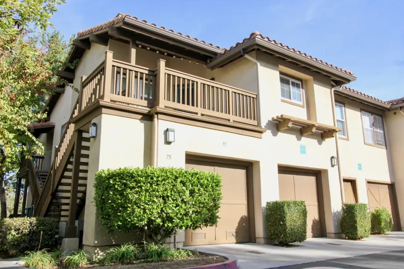 A tan and brown homes with garages in Los Portillos community in Rancho Santa Margarita, California.