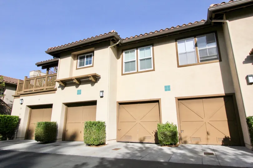 The Los Portillos community multi family housing units with tiled roofs, garages and covered balconies in Rancho Santa Margarita, California