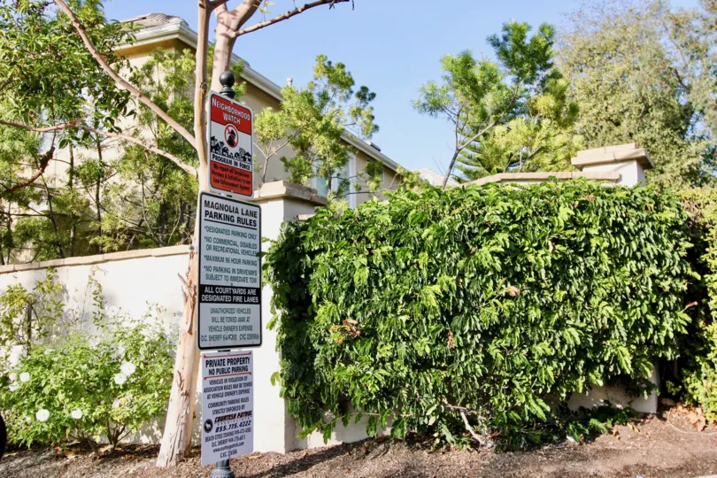 Green trees with sign boards near villa of Magnolia of Rancho Santa Margarita