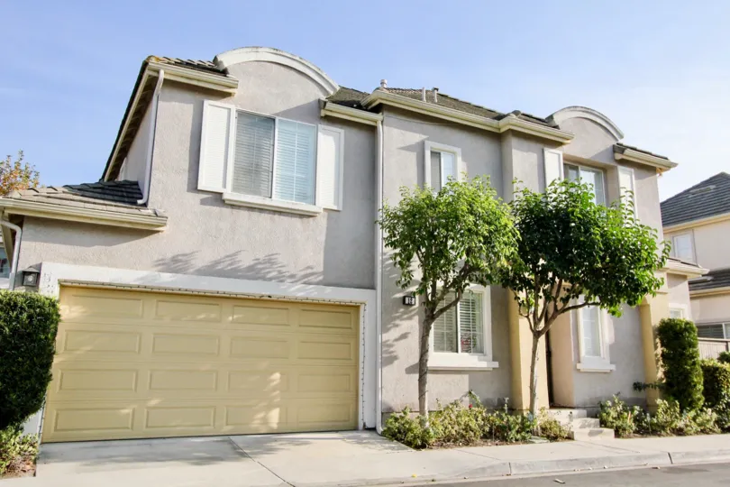 A yellow garage door sits on a gray building in the Magnolia community