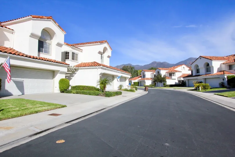 Tiled roof multi family housing units with garages and a lovely mountain view in the community of Marbella in Rancho Santa Margarita, California