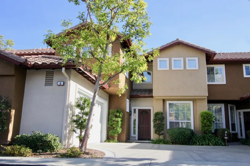 Entry view of two story residences in Sausalito, in Rancho Santa Margarita, California. Residence has attached two car garage.
