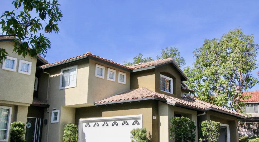 A sunny day in the area of Sausalito, outside, trees, condo, garages, bushes, windows, sky