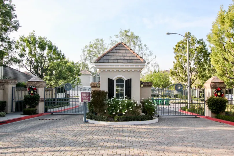 A white flowering bush sits in front of the guard shack at the Sea Country condos