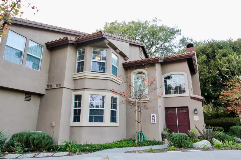 A brown house with red door in Serabrisa in Rancho Santa Margarita, CA