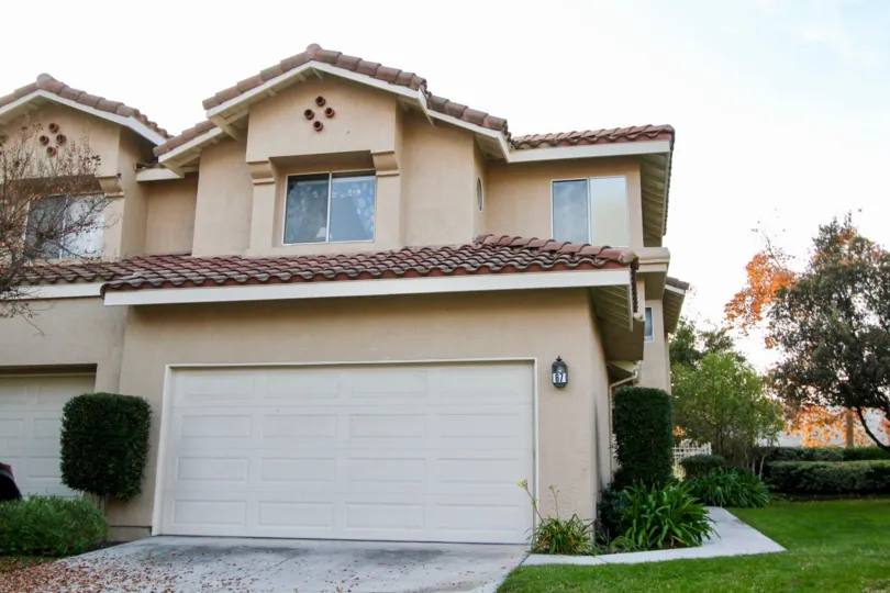 Four circles forming a diamond sit on a wall of a townhome at Sierra Verde