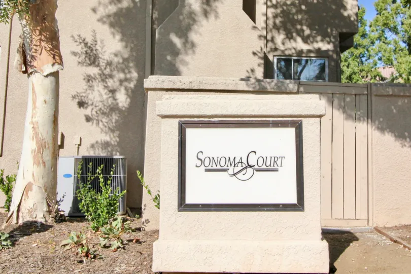 THE FLAT IN THE SONOMA COURT WITH THE SONOMA COURT WALL, TREES, PLANTS