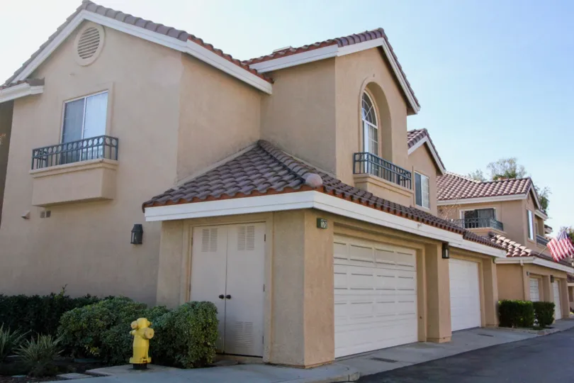 Gorgeous beige villa with red roof and attached garage in Sonoma Court.