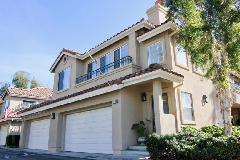 A sunny day in the area of Sonoma Court, outside, condo, balcony, tree, window, garage