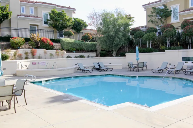 Private swimming in a sunken area for privacy with well maintained hedges and trees with ample pool deck space at Terracina