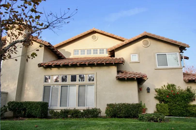 Six small square windows sit above larger windows in the Tierra Linda community.