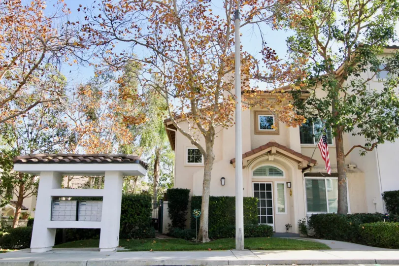 An American flag waves on front of a townhome in the Tierra Montanosa community