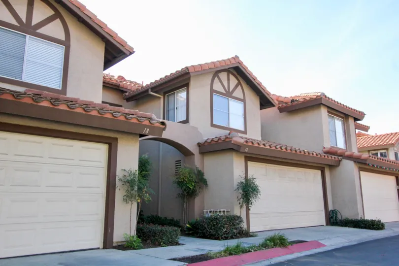 Street view of beige and brown town homes in Vista La Cuesta