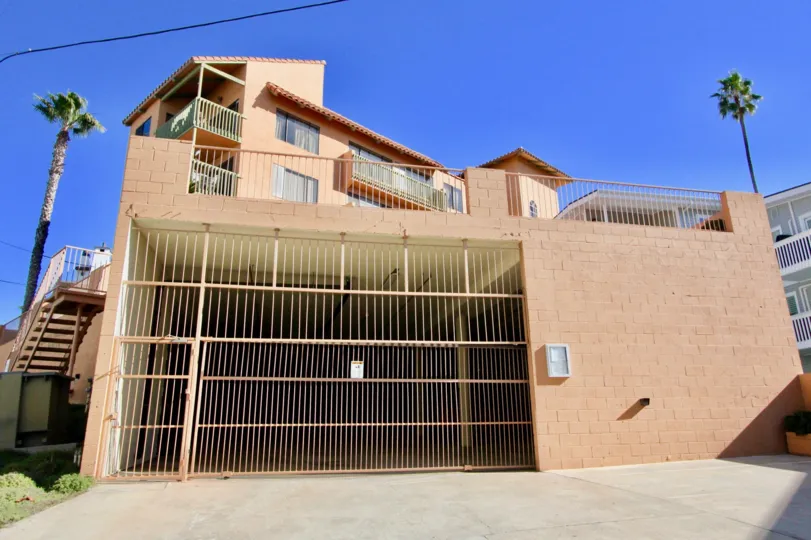 Big iron fenced gate in cellar and brick colored walls and tiles in Bahia Arenoso.