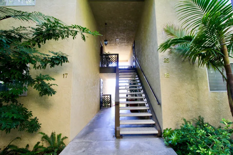 Stairs sit in a narrow, dark hallway at the Casa Contenta community
