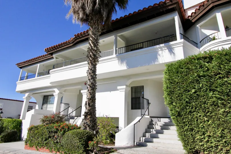 Frontal view of white Villa with balconies in Dolphin Cove Villas.