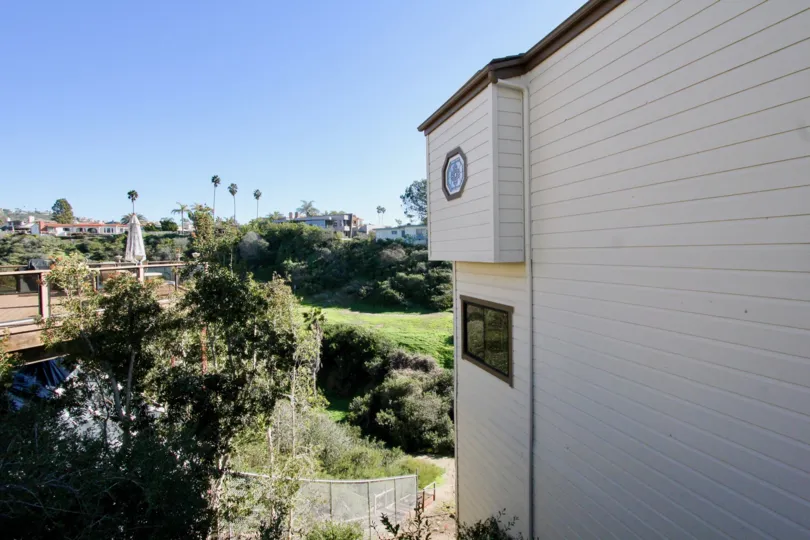 A white painted building is situated in the Driftwood Bluffs.