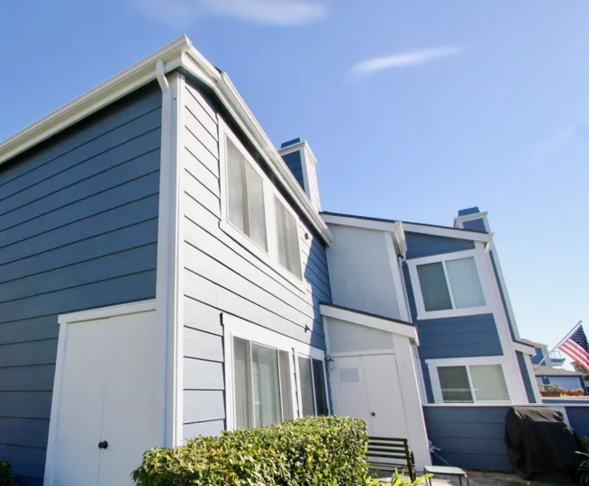 An upward view of a residence painted in blue in the Faire Harbour community.